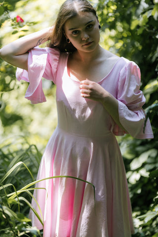 Blossom Dress – close-up front view – round neckline, puff sleeves with flared cuffs, fitted bodice, light pink cotton – Cori Tailor