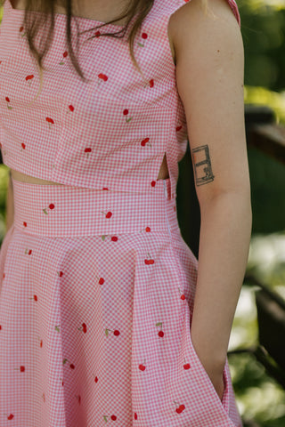 Side detail of the Lolita Top by Cori Tailor, pink gingham cotton with cherry print, structured crop top with side slit and square neckline — summer fashion.