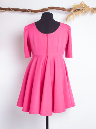 Back view of the Rose Dress by Cori Tailor in vibrant pink – vintage-inspired swing dress with a back zipper, scoop neckline, and flattering seam detailing.