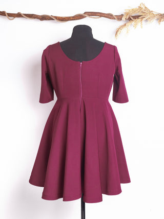 Back view of the Rose Dress by Cori Tailor – burgundy vintage-inspired swing dress featuring a full circle skirt, mid-length sleeves, and a back zipper for a smooth fit.