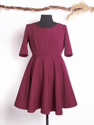 The Rose Dress by Cori Tailor – a vintage-inspired burgundy fit-and-flare swing dress with a full circle skirt and mid-length sleeves, photographed on a mannequin.