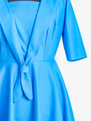 Close-up of the Sailor Moon Dress showing the sailor collar, front tie detail, and structured bodice. Handmade in bold blue by Cori Tailor.